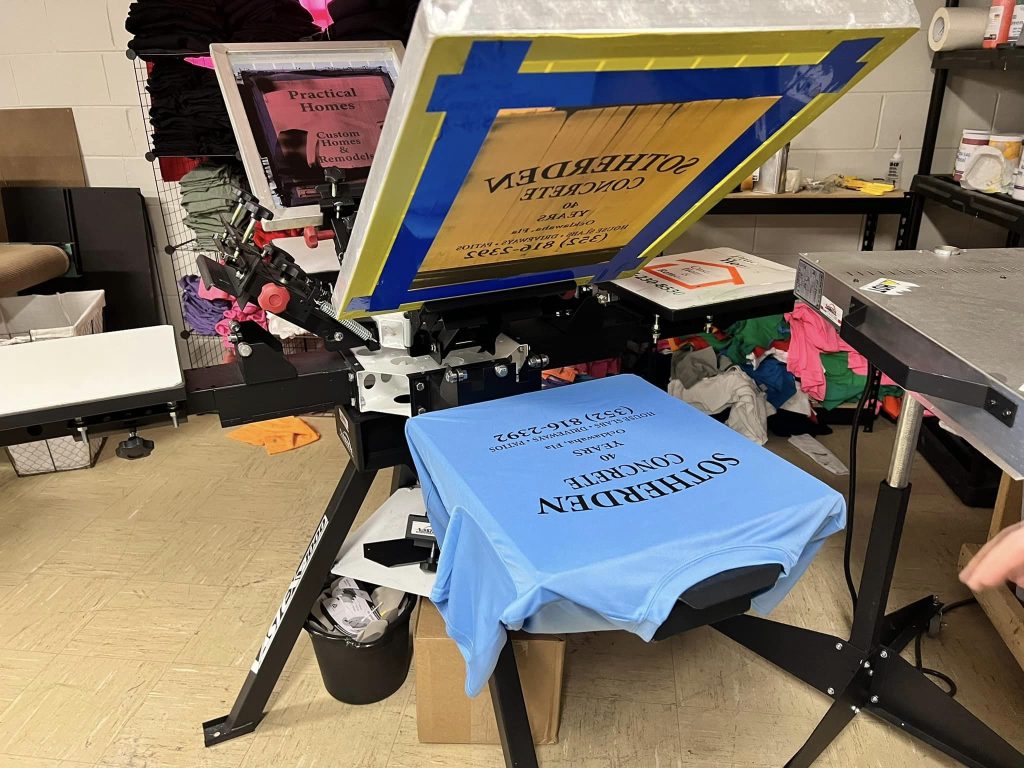 Custom shirts being screen printed at Graphicten